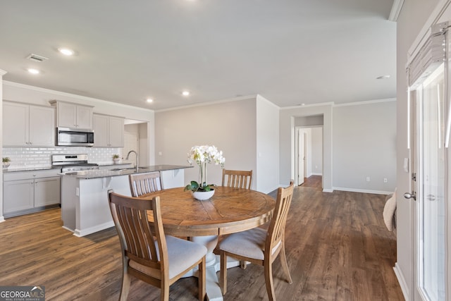 dining space with recessed lighting, visible vents, dark wood finished floors, and ornamental molding