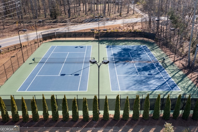 view of tennis court with fence