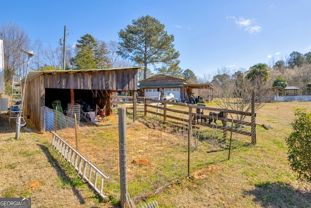 view of yard featuring an outdoor structure and fence