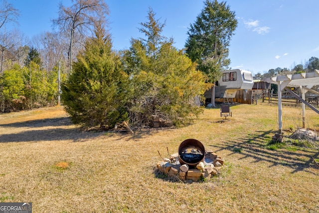 view of yard with a fire pit