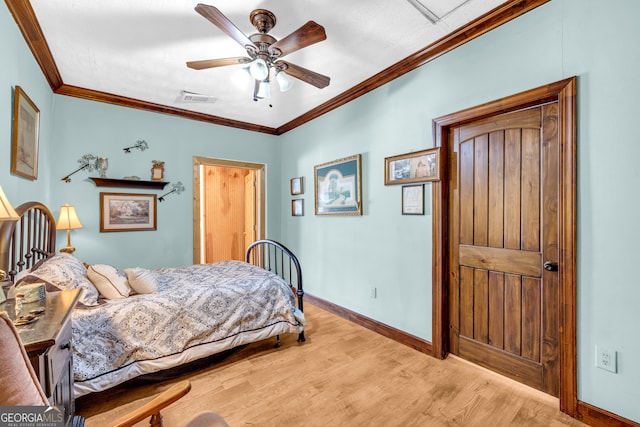 bedroom featuring baseboards, visible vents, ceiling fan, ornamental molding, and wood finished floors