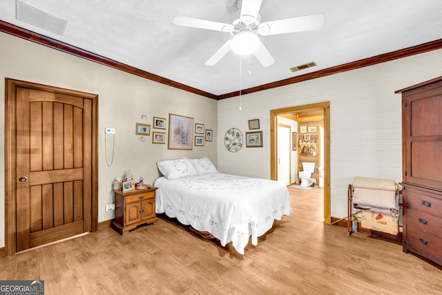 bedroom featuring light wood-style flooring, visible vents, baseboards, and ornamental molding