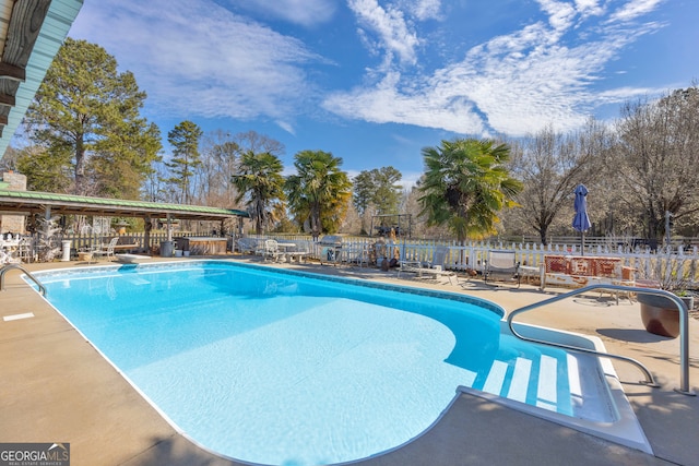 view of swimming pool featuring a fenced in pool, a patio, and fence