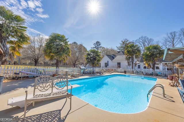 view of swimming pool with a patio area, fence, and a fenced in pool