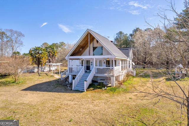 back of house with stairs, a yard, and a porch