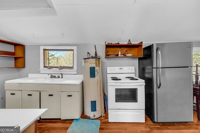 kitchen with open shelves, electric range, freestanding refrigerator, electric water heater, and a sink