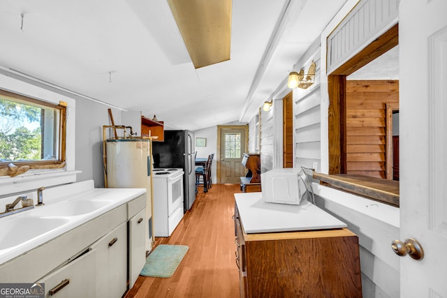 kitchen with light wood-style flooring, a sink, vaulted ceiling, electric stove, and light countertops