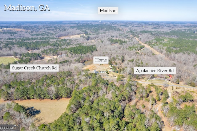 bird's eye view featuring a wooded view