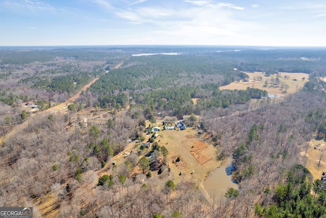 drone / aerial view featuring a wooded view