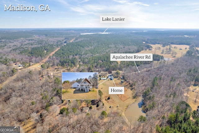 bird's eye view featuring a wooded view