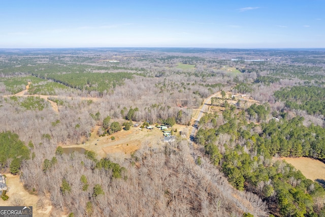 birds eye view of property with a view of trees