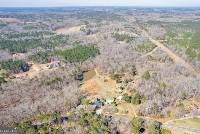 birds eye view of property featuring a view of trees