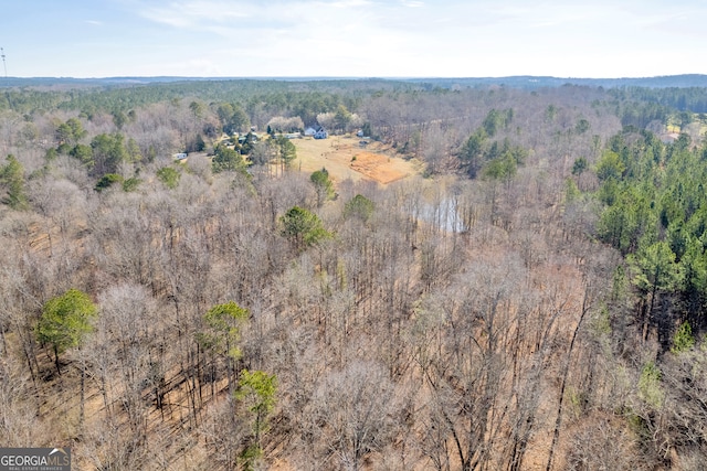 birds eye view of property with a view of trees