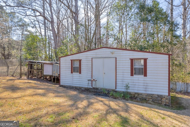 view of outbuilding with an outbuilding and fence