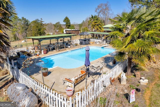 view of swimming pool featuring fence and a fenced in pool