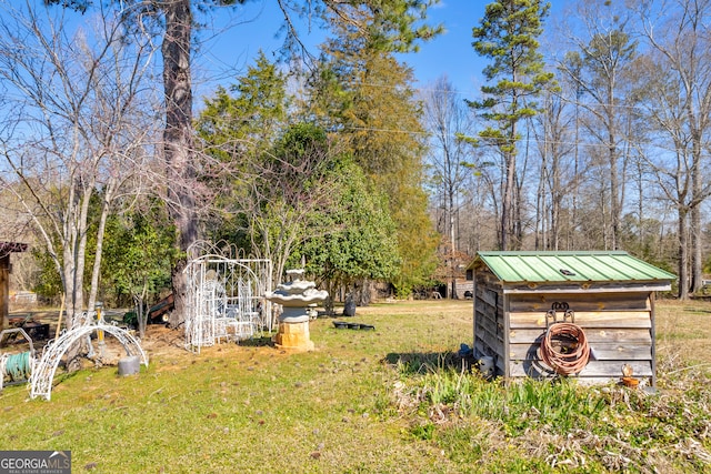 view of yard with a shed and an outbuilding