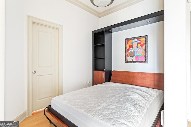 3445 Stratford Rd NE Unit 1605, Atlanta, GA 30326 - bedroom featuring crown molding, light wood finished floors, and baseboards