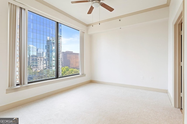 3445 Stratford Rd NE Unit 1605, Atlanta, GA 30326 - carpeted empty room with ornamental molding, a skyline view, ceiling fan, and baseboards