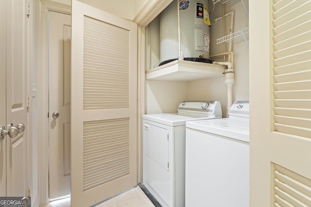 3445 Stratford Rd NE Unit 1605, Atlanta, GA 30326 - laundry area featuring water heater, washer and dryer, and light tile patterned floors