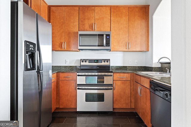 3445 Stratford Rd NE Unit 1605, Atlanta, GA 30326 - kitchen featuring stainless steel appliances, a sink, and brown cabinetry