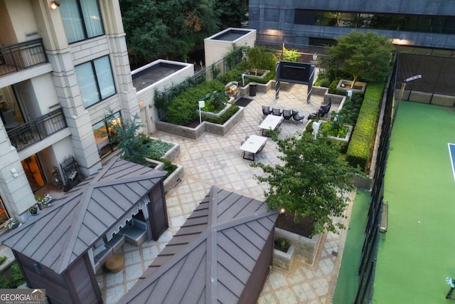 view of property's community featuring outdoor dining area and a patio area