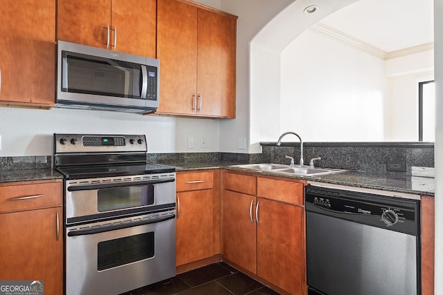 3445 Stratford Rd NE Unit 1605, Atlanta, GA 30326 - kitchen with appliances with stainless steel finishes, a sink, ornamental molding, arched walkways, and dark stone counters