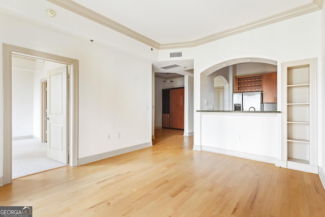 3445 Stratford Rd NE Unit 1605, Atlanta, GA 30326 - unfurnished living room with crown molding, light wood finished floors, and baseboards