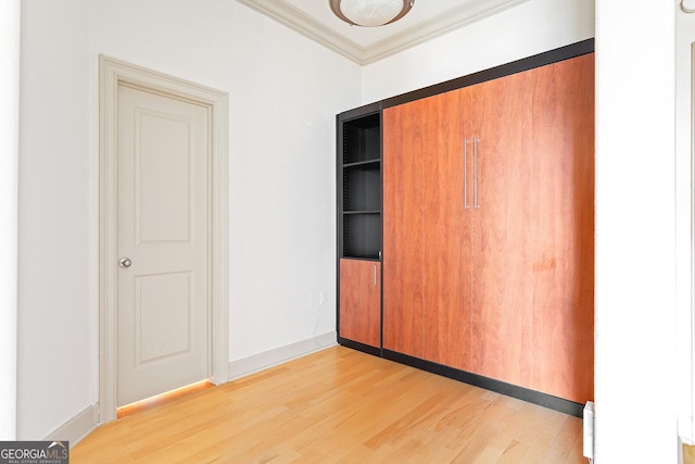 3445 Stratford Rd NE Unit 1605, Atlanta, GA 30326 - unfurnished bedroom featuring light wood-type flooring, crown molding, a closet, and baseboards