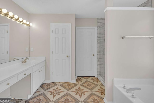 bathroom with a washtub, a tile shower, vanity, and baseboards