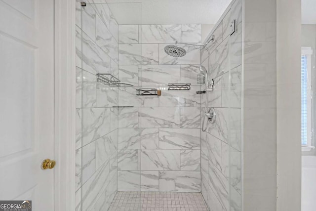 bathroom with tiled shower