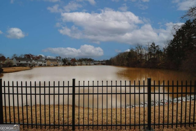 property view of water featuring fence