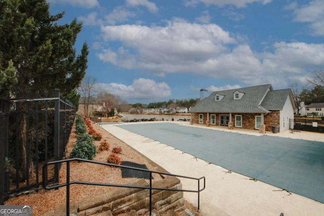 view of swimming pool featuring fence