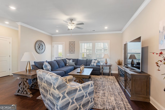 living room with ornamental molding, dark wood finished floors, visible vents, and baseboards