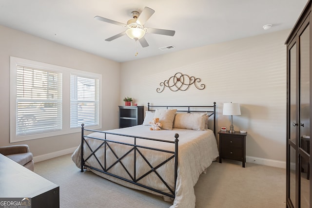 bedroom featuring a ceiling fan, light colored carpet, visible vents, and baseboards