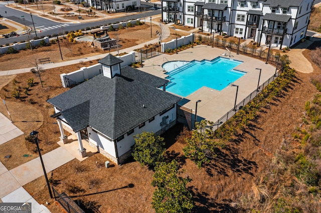 pool with a fenced backyard and a patio