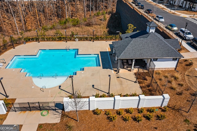 community pool featuring a patio area and fence