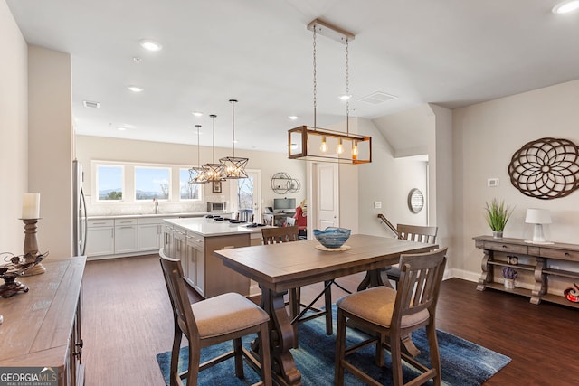 dining room featuring recessed lighting, lofted ceiling, visible vents, dark wood-type flooring, and baseboards