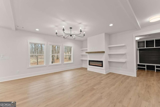 unfurnished living room featuring recessed lighting, visible vents, baseboards, light wood-type flooring, and a glass covered fireplace