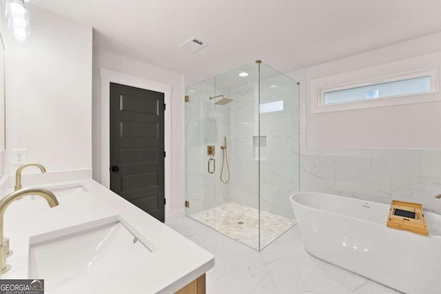 full bathroom featuring a sink, visible vents, marble finish floor, a soaking tub, and a marble finish shower