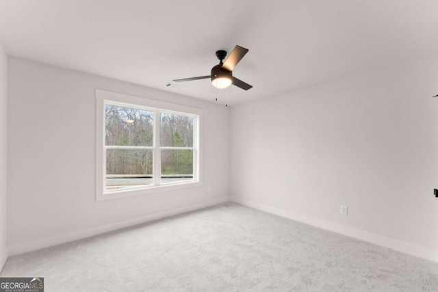 unfurnished room featuring carpet floors, visible vents, and baseboards