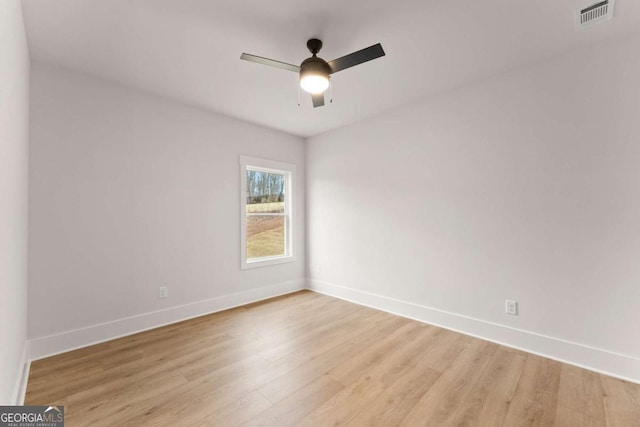 unfurnished room with light wood-style floors, visible vents, baseboards, and a ceiling fan