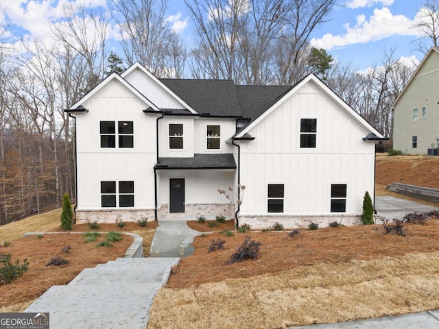 modern farmhouse style home featuring a shingled roof and board and batten siding