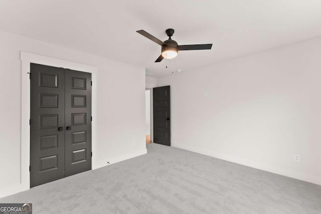 interior space with a ceiling fan and carpet flooring