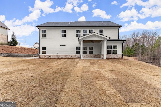 back of house featuring a patio area and a lawn