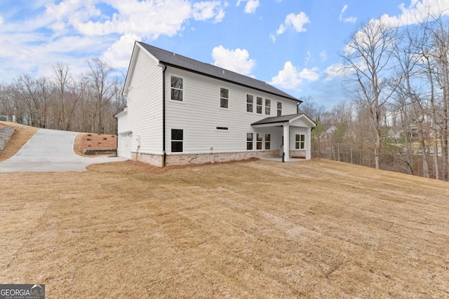 rear view of property featuring a yard