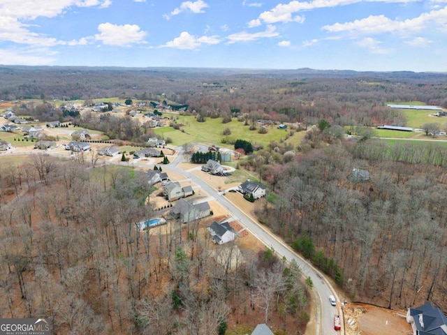 birds eye view of property featuring a view of trees