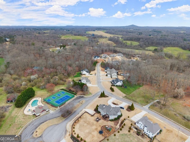 drone / aerial view featuring a view of trees