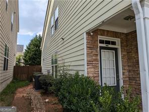 735 Briarhurst Ct, Lawrenceville, GA 30046 - view of front facade featuring driveway, an attached garage, and stone siding