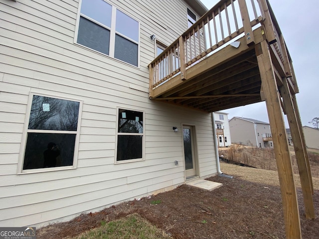 rear view of house featuring a wooden deck