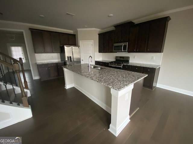 kitchen with dark wood-style floors, crown molding, appliances with stainless steel finishes, and a sink